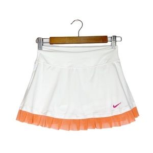 Nike white tennis mini skirt with ruffled orange trim on the bottom